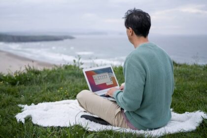 digital nomad working by the sea with laptop